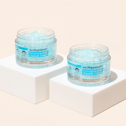 Masque BAR my iN.gredients Hyaluronic Acid Capsule Cream in an open glass jar, showing its blue gel-cream and hydrating capsules, a vegan, fragrance-free moisturiser with hyaluronic acid, niacinamide and shea butter for dry, mature, dehydrated skin.