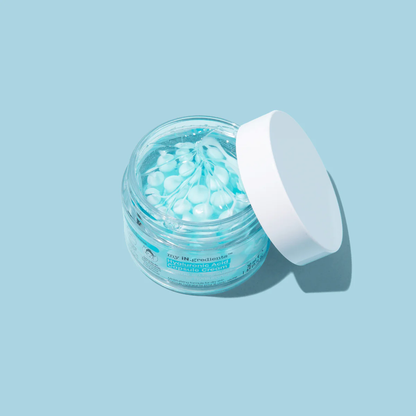 Masque BAR my iN.gredients Hyaluronic Acid Capsule Cream in an open glass jar, showing its blue gel-cream and hydrating capsules, a vegan, fragrance-free moisturiser with hyaluronic acid, niacinamide and shea butter for dry, mature, dehydrated skin.