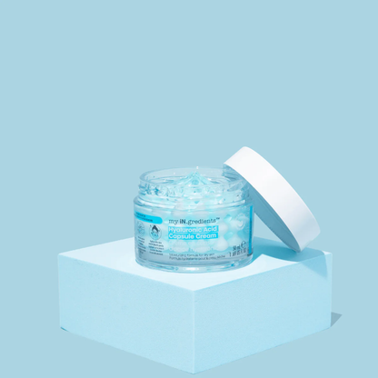 Masque BAR my iN.gredients Hyaluronic Acid Capsule Cream in an open glass jar, showing its blue gel-cream and hydrating capsules, a vegan, fragrance-free moisturiser with hyaluronic acid, niacinamide and shea butter for dry, mature, dehydrated skin.