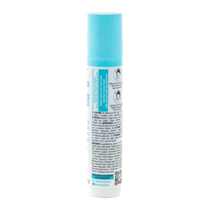 Slim turquoise tube of Masque BAR my iN.gredients Hyaluronic Acid Jade Stone Under-Eye Roller with jade tip exposed on a blue background, a cooling vegan treatment that hydrates, brightens dark circles and softens fine lines under the eyes.