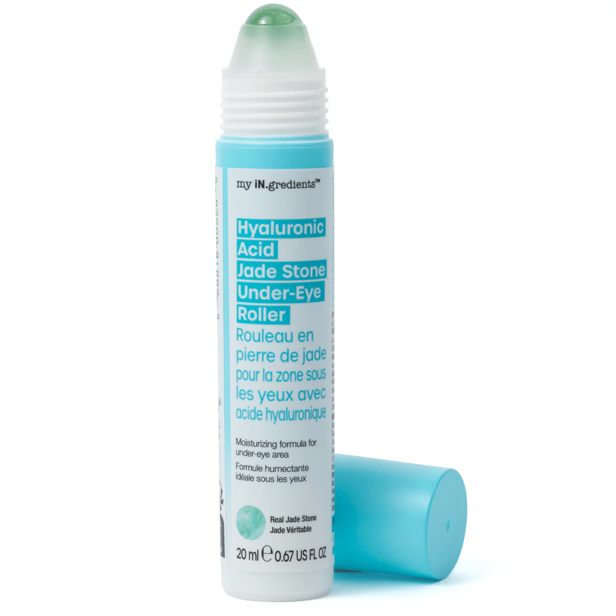 Slim turquoise tube of Masque BAR my iN.gredients Hyaluronic Acid Jade Stone Under-Eye Roller with jade tip exposed on a blue background, a cooling vegan treatment that hydrates, brightens dark circles and softens fine lines under the eyes.