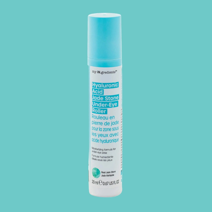 Slim turquoise tube of Masque BAR my iN.gredients Hyaluronic Acid Jade Stone Under-Eye Roller with jade tip exposed on a blue background, a cooling vegan treatment that hydrates, brightens dark circles and softens fine lines under the eyes.