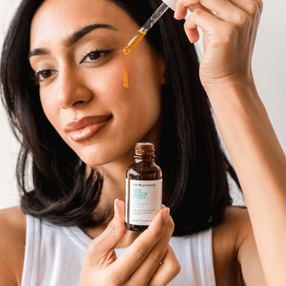 Amber glass bottle of my iN.gredients 100% Rose Hip Seed Oil 30ml with white dropper and minimal turquoise label, shown against a soft blue background, highlighting its pure, vegan formula for hydrating and soothing dull, dry, itchy facial skin.