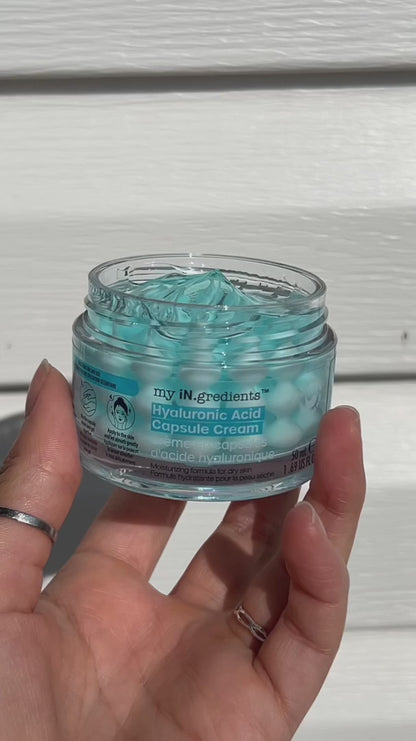 Masque BAR my iN.gredients Hyaluronic Acid Capsule Cream in an open glass jar, showing its blue gel-cream and hydrating capsules, a vegan, fragrance-free moisturiser with hyaluronic acid, niacinamide and shea butter for dry, mature, dehydrated skin.